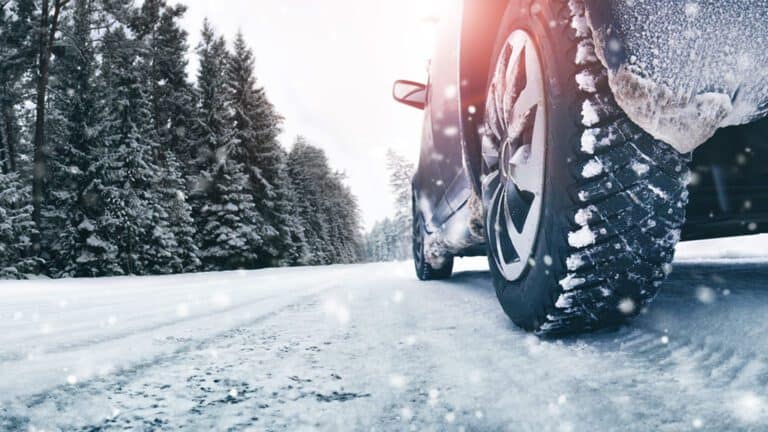 Closeup of car tires in winter on the road