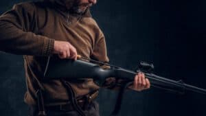 Opening of the spring hunting season. A man cleans rifle barrel