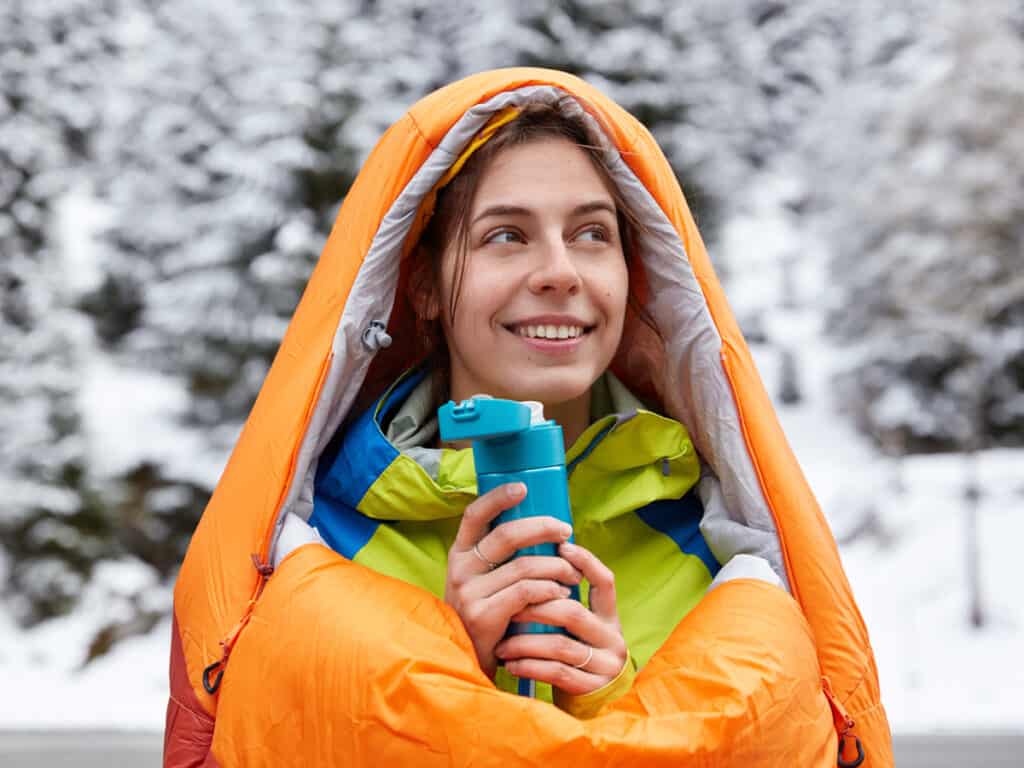 Staying warm in a winter sleeping blanket, while drinking water