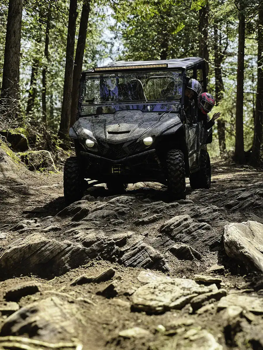 Off-roading with a SxS down a steep rocky descent on the E107 North trail