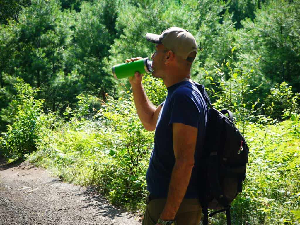 Hiker drinking to stay hydrated
