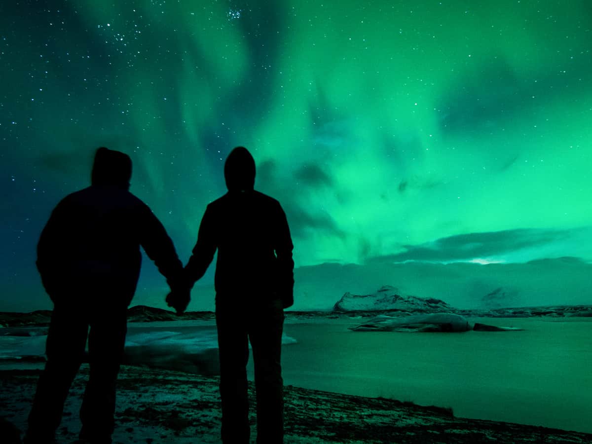 Outdoor Date Idea - A couple looking at the northern lights
