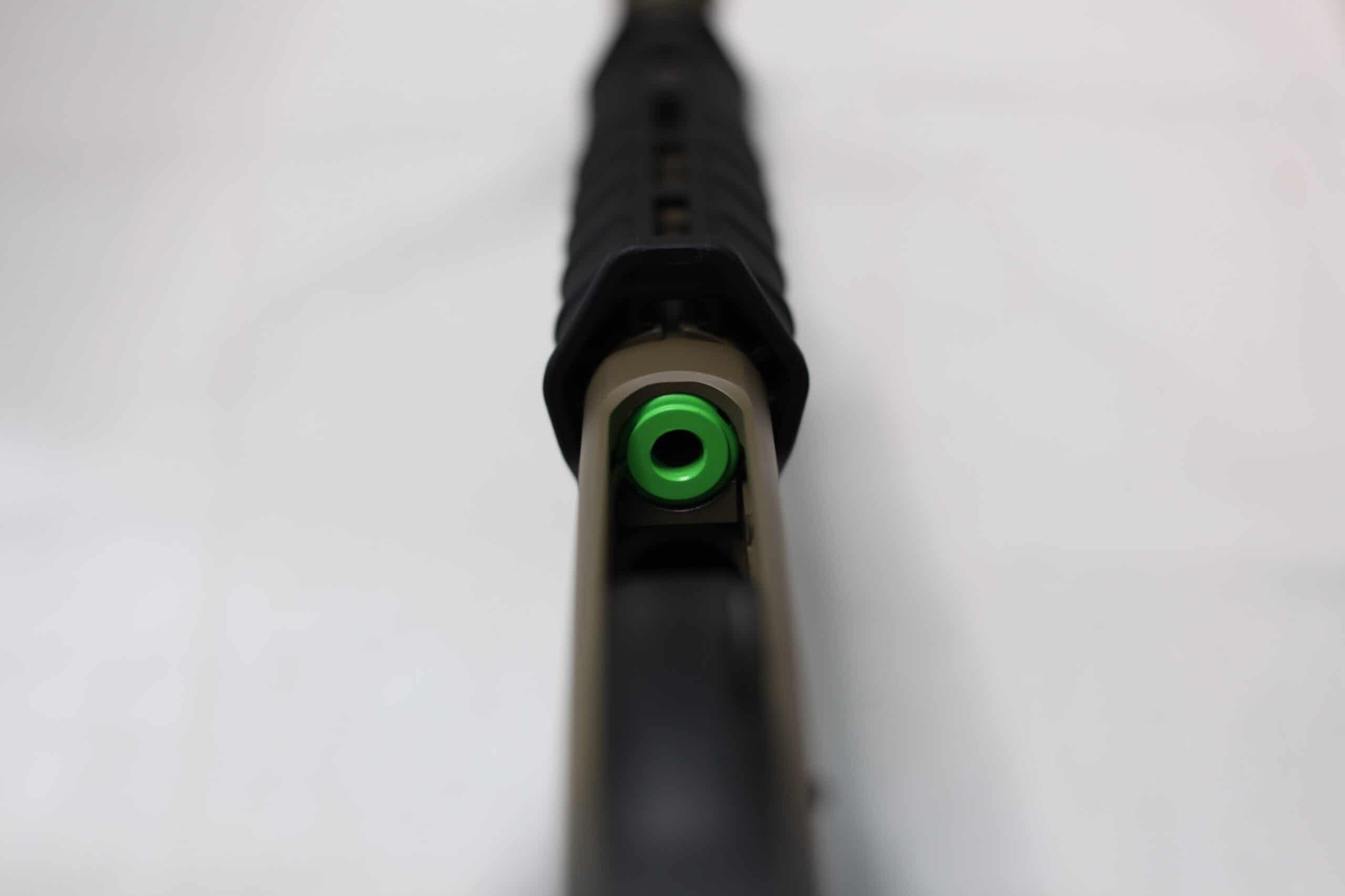 close-up of S&J Hardware No Jam Follower in green on the Custom Remington 870 to improve shooting and prevent jams