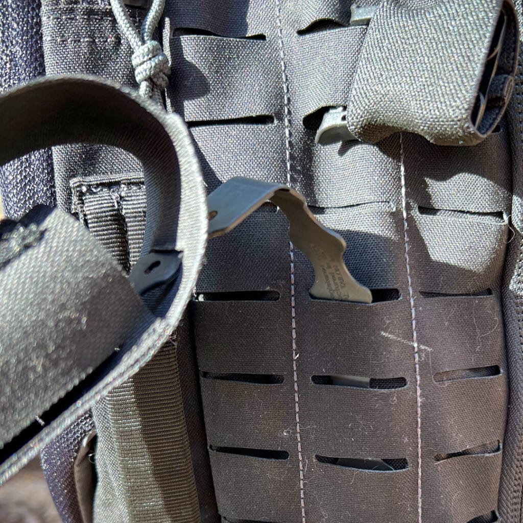 Pictured is the Malice Clip from the Rugged Tourniquet Pouch Inserted into MOLLE Webbing