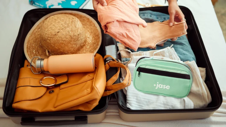 Traveller packing her suitcase with the JaseGo Medical Kit