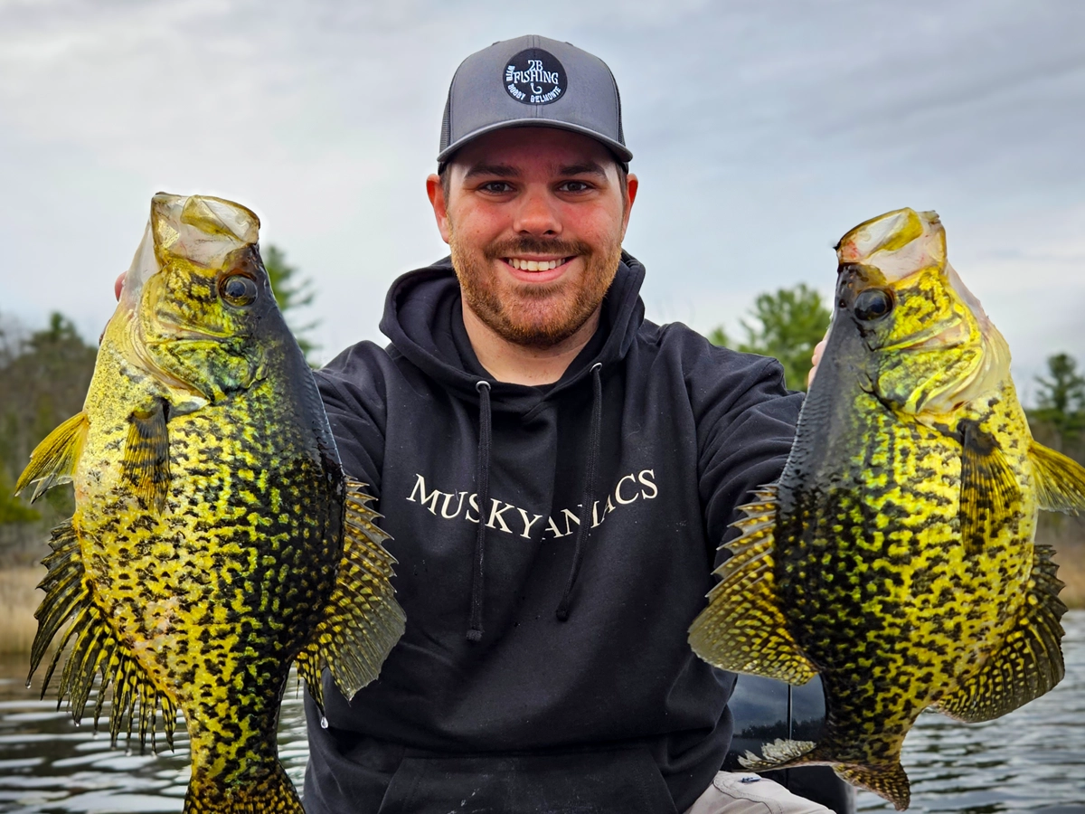 Ontario's local fishing guide Bobby Belmonte holds up his impressive catch of two large crappies