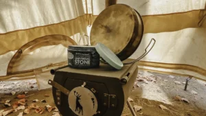 Universal Stone sitting on top of a wood stove inside a camping tent