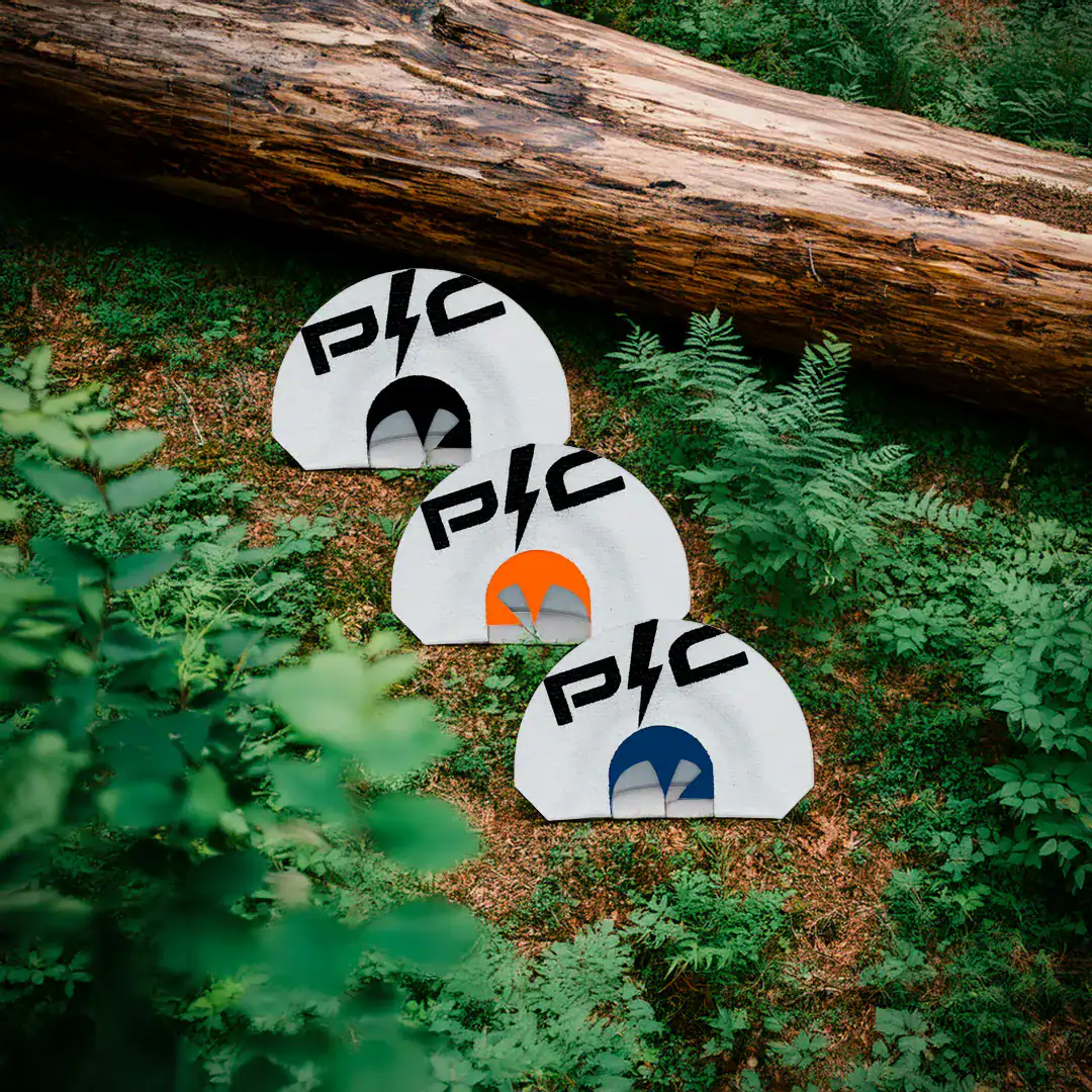 three power calls for calling in turkeys laying on the forest floor