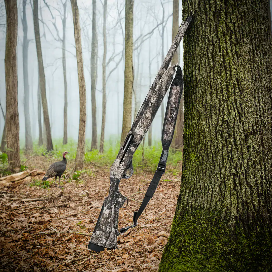 Stoeger turkey shotgun up against a tree in the woods during spring turkey season