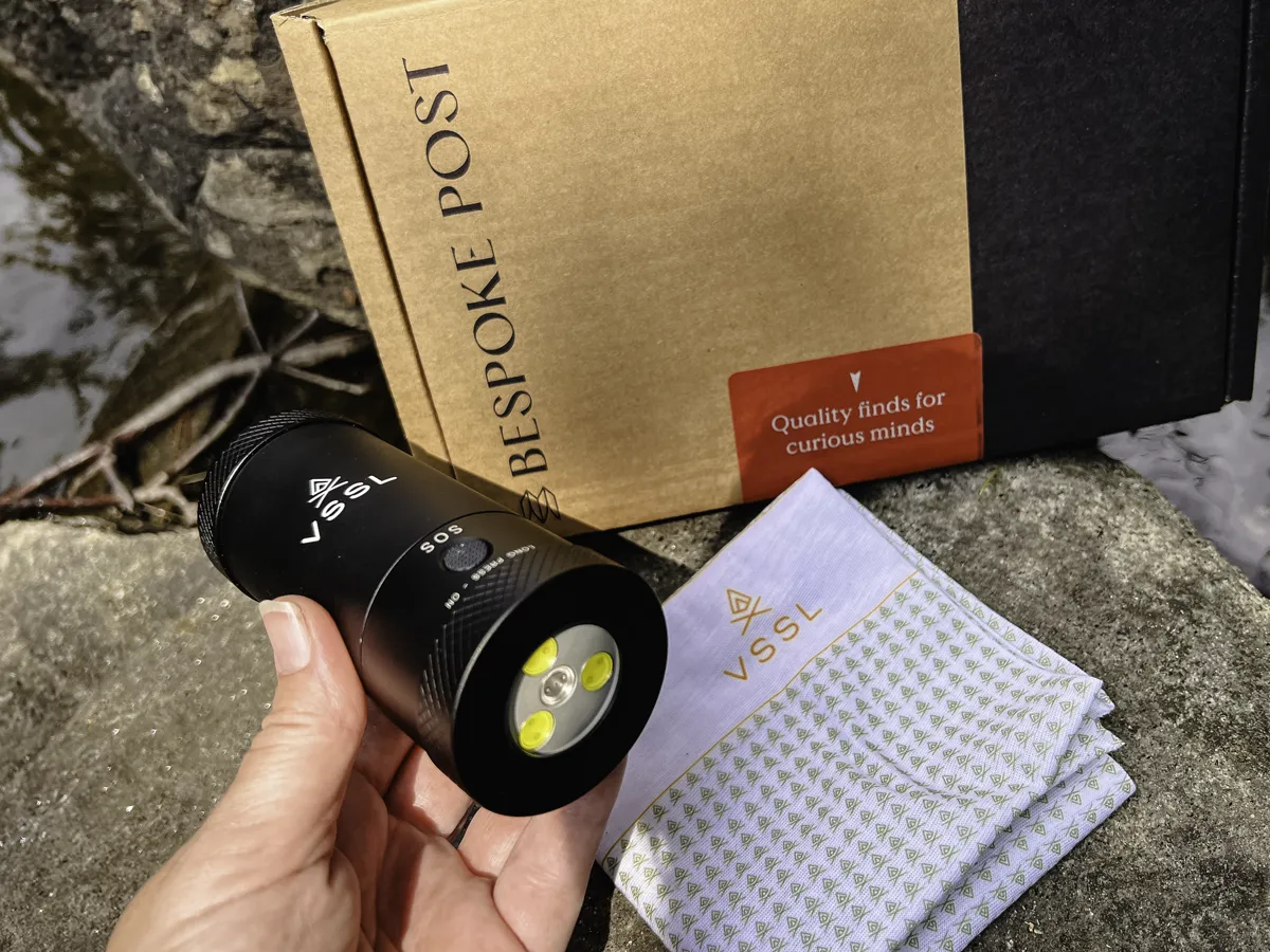 holding a mini utility light from a Bespoke curated gift box