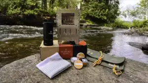 Contents of the Bespoke Post Subscription Box - Outdoors Edition laid out on a rock