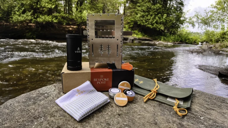 Contents of the Bespoke Post Subscription Box - Outdoors Edition laid out on a rock