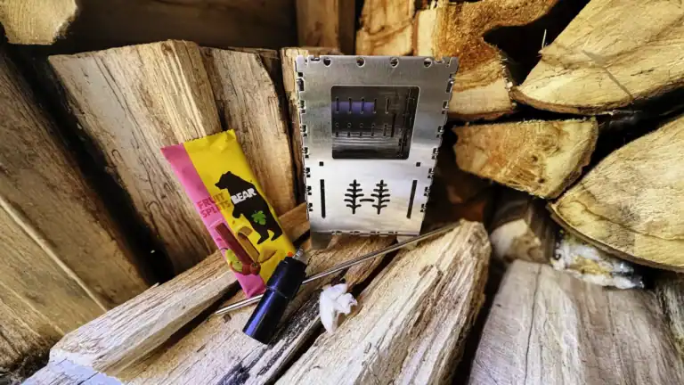 emergency add-ons: foldable wood-burning stove, lighter wrapped in duct tape, vaseline-laden cotton ball, stainless steel straw, and snack