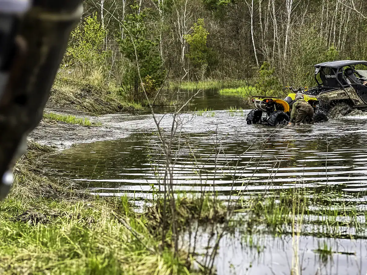 Off-roaders in a SXS and ATV water crossing at Jack's Creek on the Hydro Line