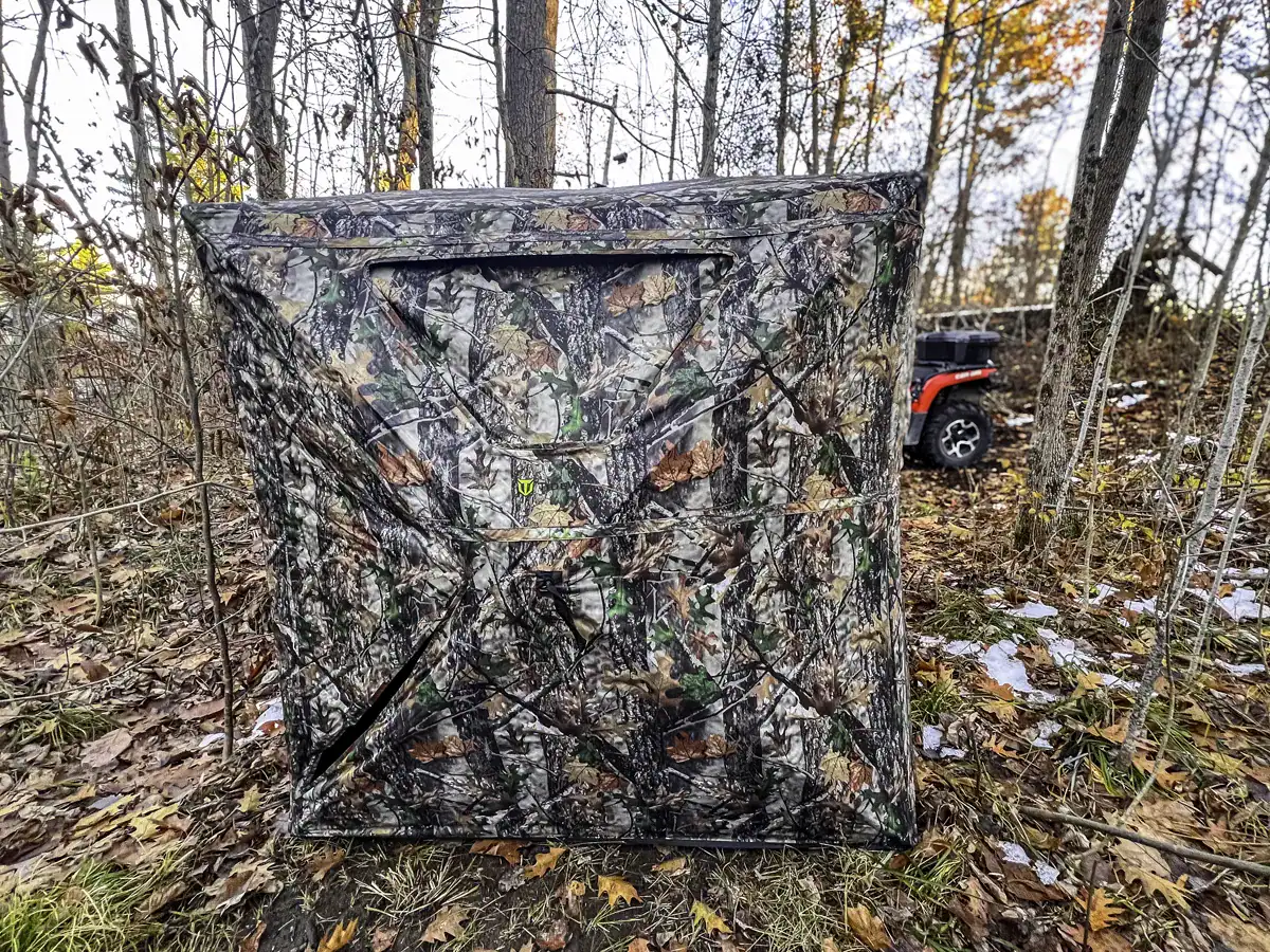 TideWe VisST 270 hunting blind in the woods beside an ATV