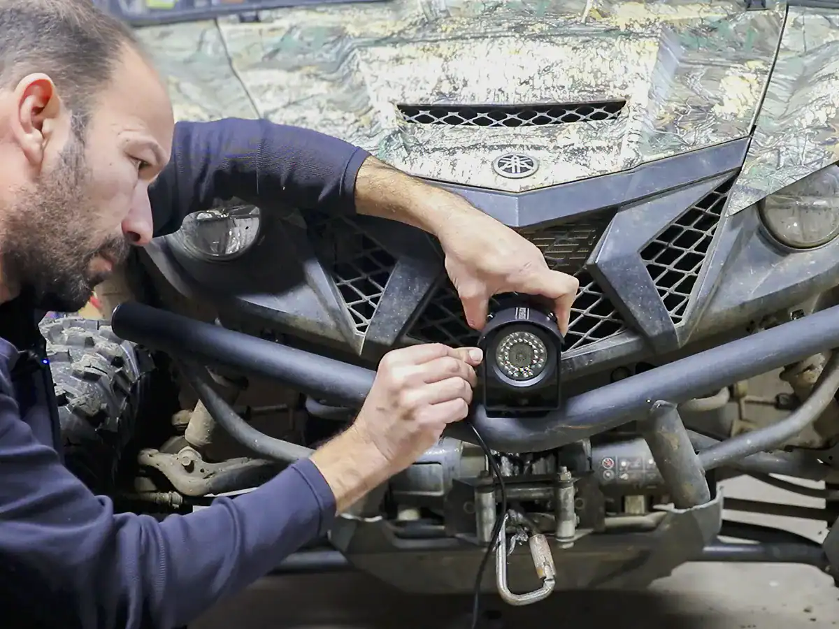 TadiBrothers Tactical Camera Review: A Heavy-Duty Backup System for Commercial & Off-Road Use 5 installing TadiBrothers heavy-duty camera to the front of a Yamaha Wolverine side-by-side