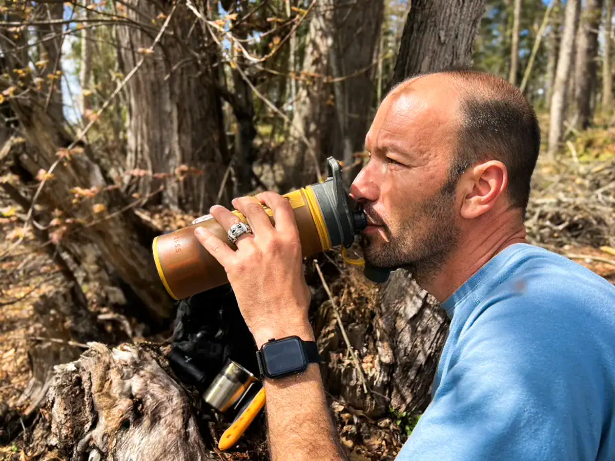 Best Water Bottles for Hiking & Camping: How to Choose (+ Our Tested Picks) 5 Drinking from a GeoPress water filter bottle for emergency survival to rehydrate