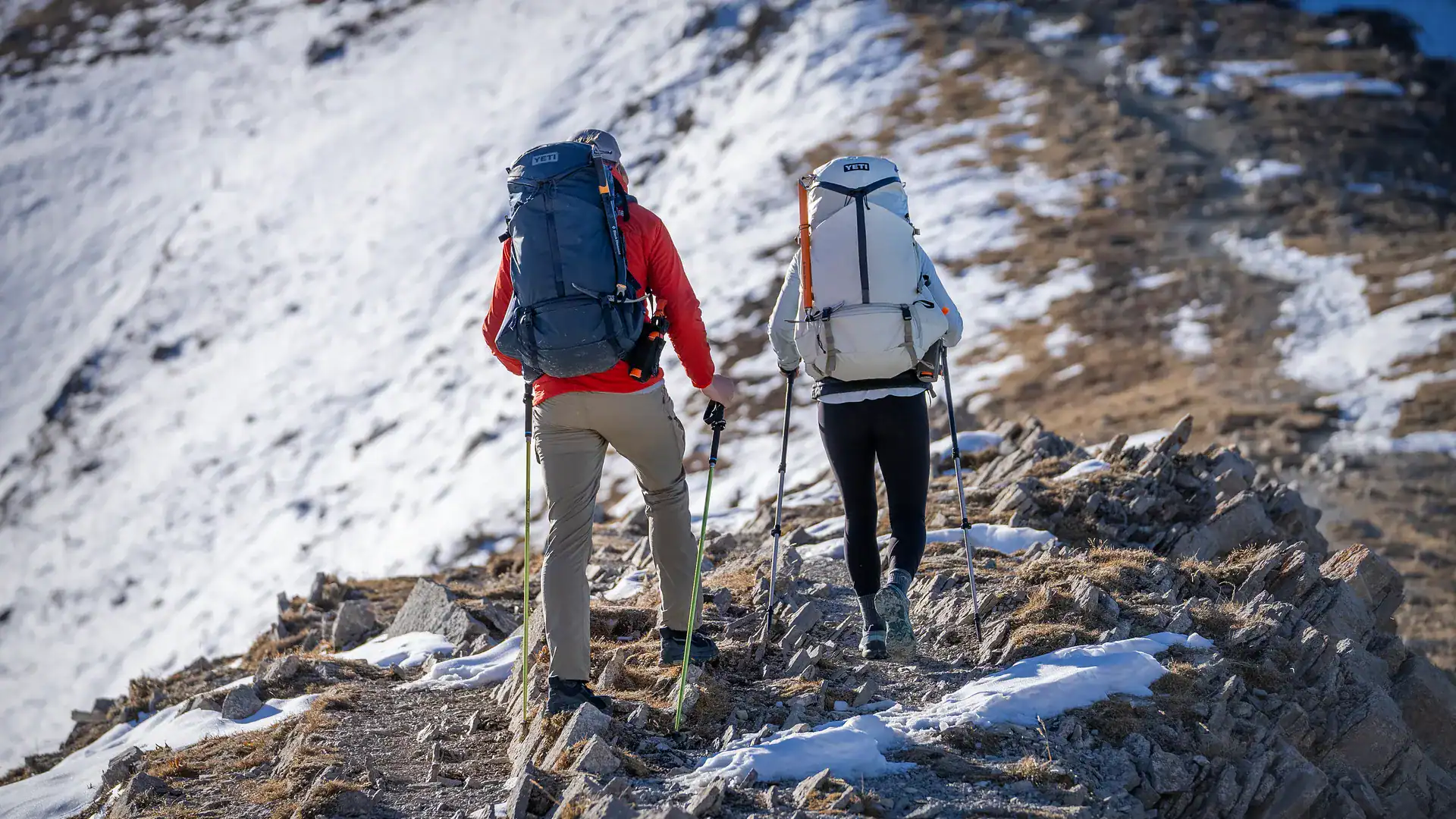 hikers trekking up a mountain carrying the new YETI Skala 60L hiking backpack