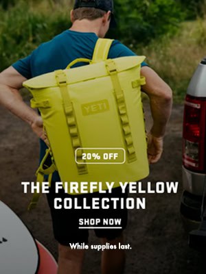 Beach goer carrying the fire fly yellow hopper cooler from YETI ad