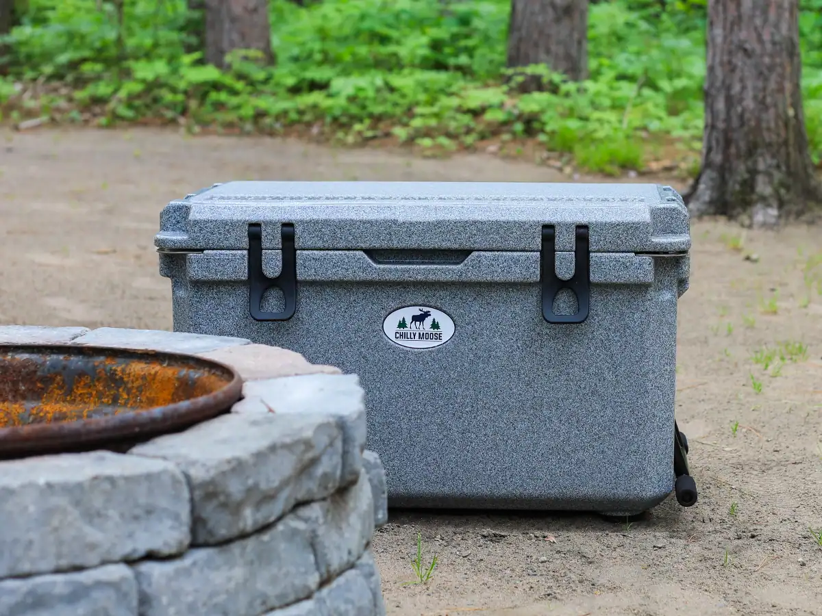 Chilly Moose Coolers Review: Bowen vs Harbour Bucket vs Explorer (Tested) 25 Chilly Moose 55l Wheeled Cooler beside a firepit at a campsite