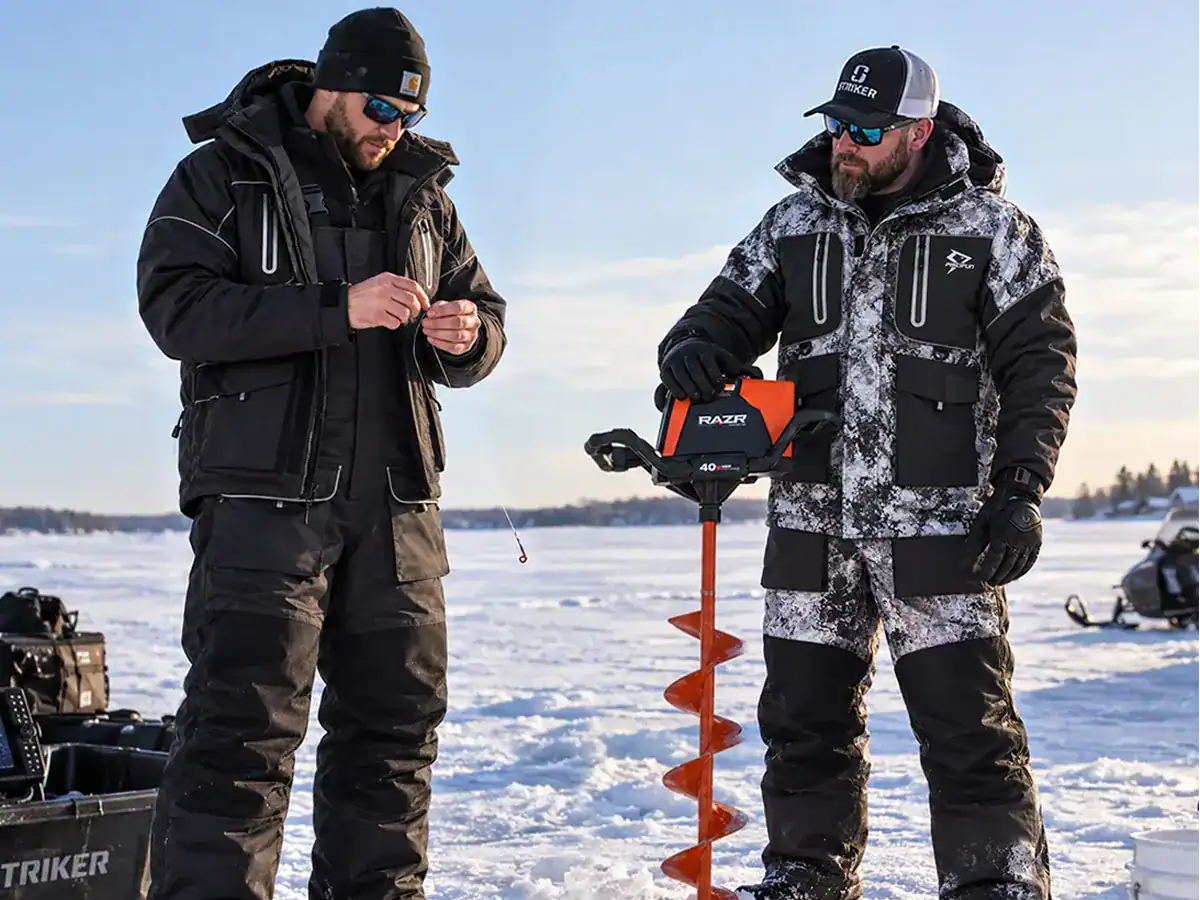 The New Piscifun Ice Fishing Suit is Finally Here - Is It Worth the Hype? 1 two anglers setting up their ice fishing spot wearing piscifun's ice fishing suits